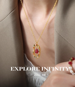 Close-up of gold titanium necklace with agate drop pendant on a fashion model