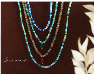 Detailed close-up of layered bohemian necklace with colorful beads and agate pendants