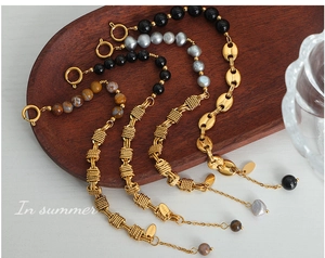 Detailed set of four stainless steel bracelets with gray pearls and agate beads