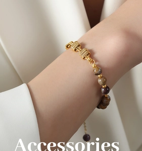 Detail of vintage brass knot chain bracelet with natural agate stone beads on wrist