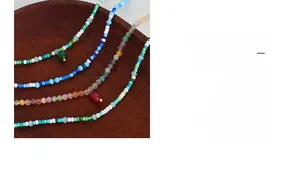 Macro detail of handmade colorful beaded necklace with elegant natural stone pendants