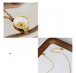 Close-up of daisy pendant with white shell inlay and 18K gold plated clasp details