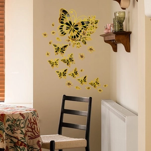 Detail of elegant black and gold butterfly wall stickers with floral vine accents for decor
