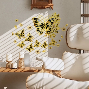 Detailed view of hand-painted gold and black butterfly wall stickers in a modern living room
