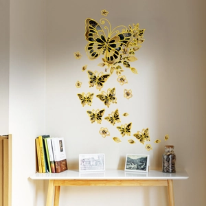 Detailed view of black and gold floral butterfly wall stickers in a cozy room setting