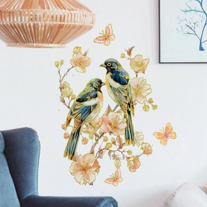 Floral wall stickers with gold birds and pink cherry blossoms on white living room wall