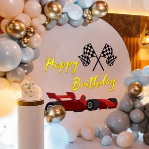 Racing car themed birthday backdrop with red F1 car and gold Happy Birthday text