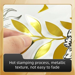 Detail of hot stamping gold leaves and black floral wall sticker with metallic finish