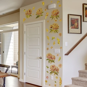 Detail of floral wall sticker with pink peonies and golden butterflies on a white door