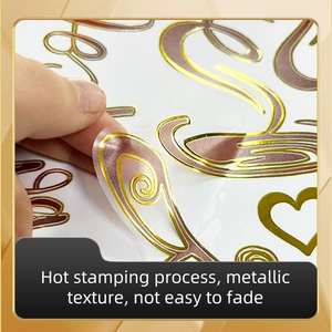 Close-up of peeling a metallic gold feather sticker with hot stamping texture