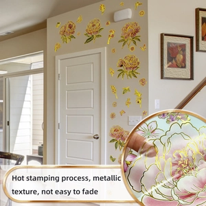 Close-up of gold foil floral wall stickers featuring pink peony and butterfly motifs