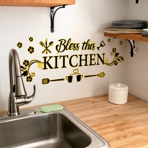 Close-up of 'Bless this KITCHEN' wall sticker with gold cutlery and floral details
