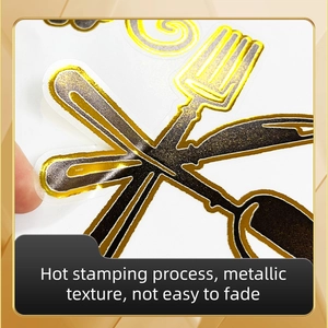 Macro detail of metallic gold foil cutlery wall stickers with hot stamping texture