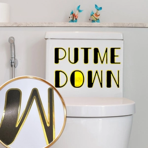 Detail of Put Me Down gold foiled bathroom sticker applied on a white toilet tank