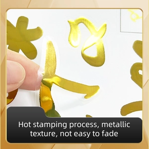 Macro detail of gold foil toilet sticker with brushed metallic texture and easy peel design