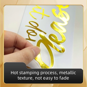 Detail showing high-gloss gold metallic hot stamping decal peeling from the backing sheet