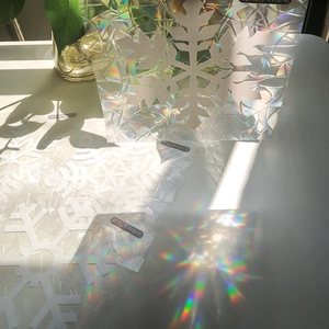 Rainbow snowflake window film showing vibrant light refraction and prismatic patterns