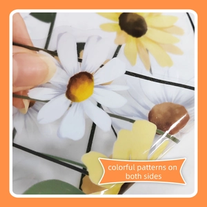 Macro view of double-sided floral window stickers featuring colorful daisies and sunflowers