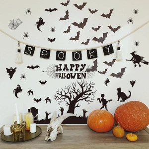 Detail of bat and ghost wall stickers arranged on a wall for a spooky Halloween atmosphere