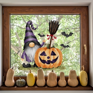 Halloween window decals featuring a gnome, pumpkin, bats, and broom on a house window