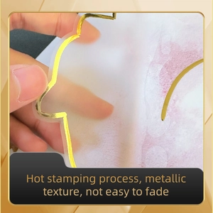 Close-up of translucent gold foil wall sticker showing hot stamping process and texture