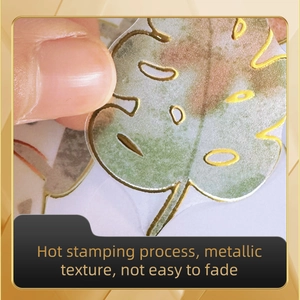 Detail of gold foil monsterra leaf wall sticker showing metallic texture and peel-off use