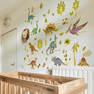 Detailed view of hand-drawn dinosaur wall decals with gold outlines in a nursery