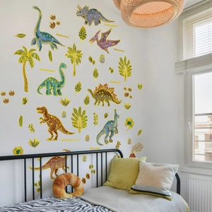 Vibrant dinosaur wall stickers with golden foil accents in a bright nursery bedroom