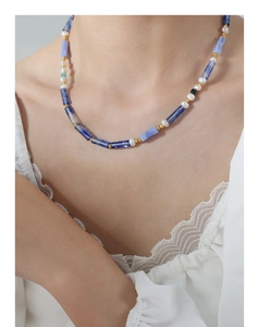 Détail du collier bohème avec pierres de cyanite bleue et perles d'eau douce sur le cou