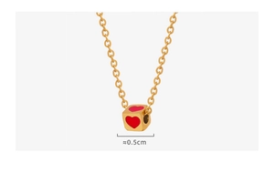 Macro shot of 0.5cm cube pendant with red hearts on a gold titanium steel chain necklace