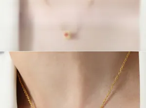 Close-up of golden necklace chain on model neck highlighting sleek link texture