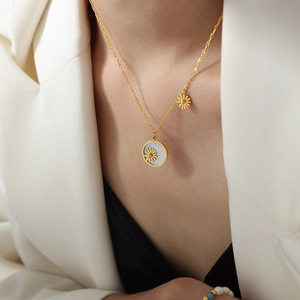 Gold-plated titanium steel daisy pendant necklace with white sea shell disk on model