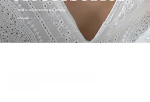 Detail of white crochet lace fabric with intricate hollow patterns and deep V-neckline