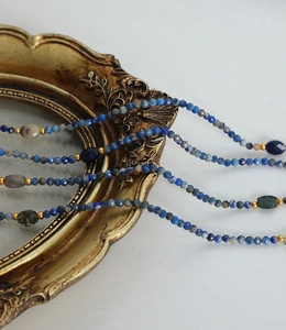 Detailed shot of Baroque beaded necklace with natural lapis lazuli and gold accents