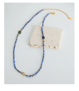 Detail of baroque beaded necklace with blue natural stones and gold lobster clasp