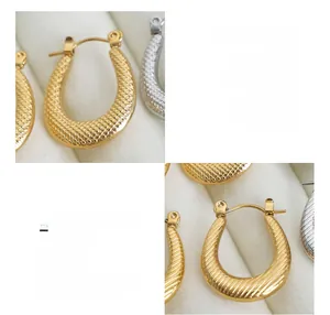 Detailed macro of 18K gold plated titanium steel U-shape earrings with striped textures