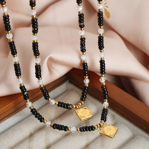 Tiger eye and black agate beaded necklace with embossed heart charms on champagne silk