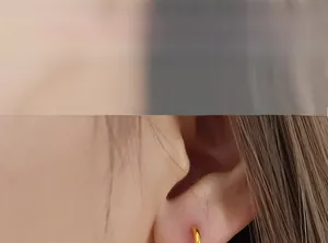 Gros plan de créoles dorées élégantes portées par un mannequin au style minimaliste