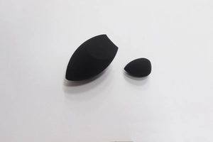 Macro detail of two black makeup sponges for foundation, large and mini sizes