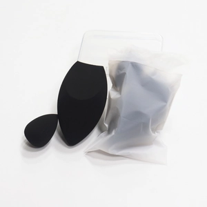 Detail view of two black beauty sponges in a small frosted pouch and clear box