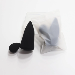 Detail view of black makeup sponge set with teardrop and cone shapes in storage case