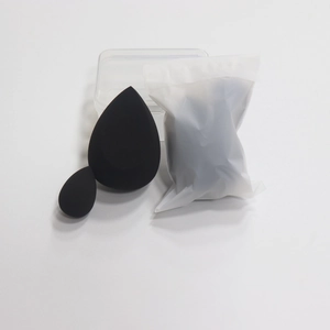 Detail of two black beauty sponges in different sizes with clear storage box and pouch