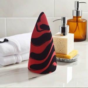 Dual-tone red and black zebra pattern makeup sponge in a sleek conical shape