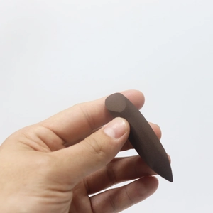 Macro detail of dark brown blending sponge with a precision slanted cut for makeup application
