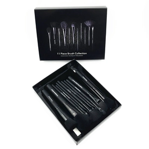 Professional 11-piece black makeup brush set with wooden handles in a stylish gift box