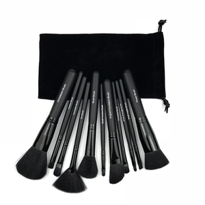 Detailed view of 11 professional black makeup brushes with labeled wooden handles