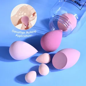 Pink makeup sponge set with various shapes and sizes displayed on a blue background