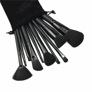 Detailed view of 11-piece black makeup brush set with matte handles and velvet pouch