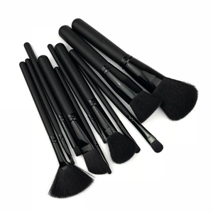 Professional 11-piece black makeup brush set with wooden handles and dense fiber bristles