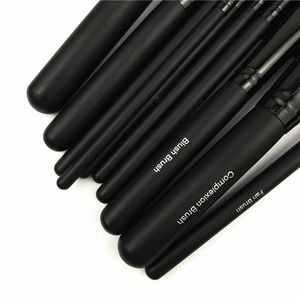 Detail of 11-piece matte black professional makeup brush set with synthetic fiber bristles
